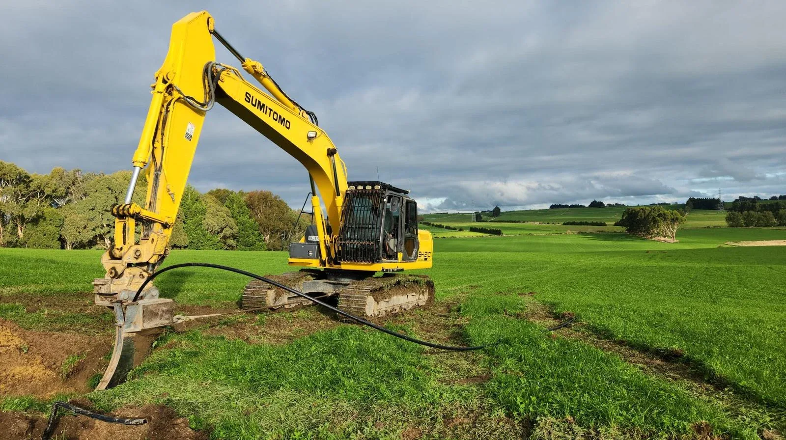 Agricultural machinery lined up for earthworks and farm support.